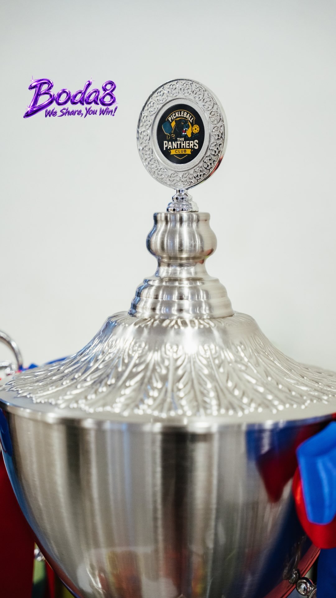Close-up of the Panthers Club pickleball trophy with the Boda8 logo and red-and-blue ribbons.