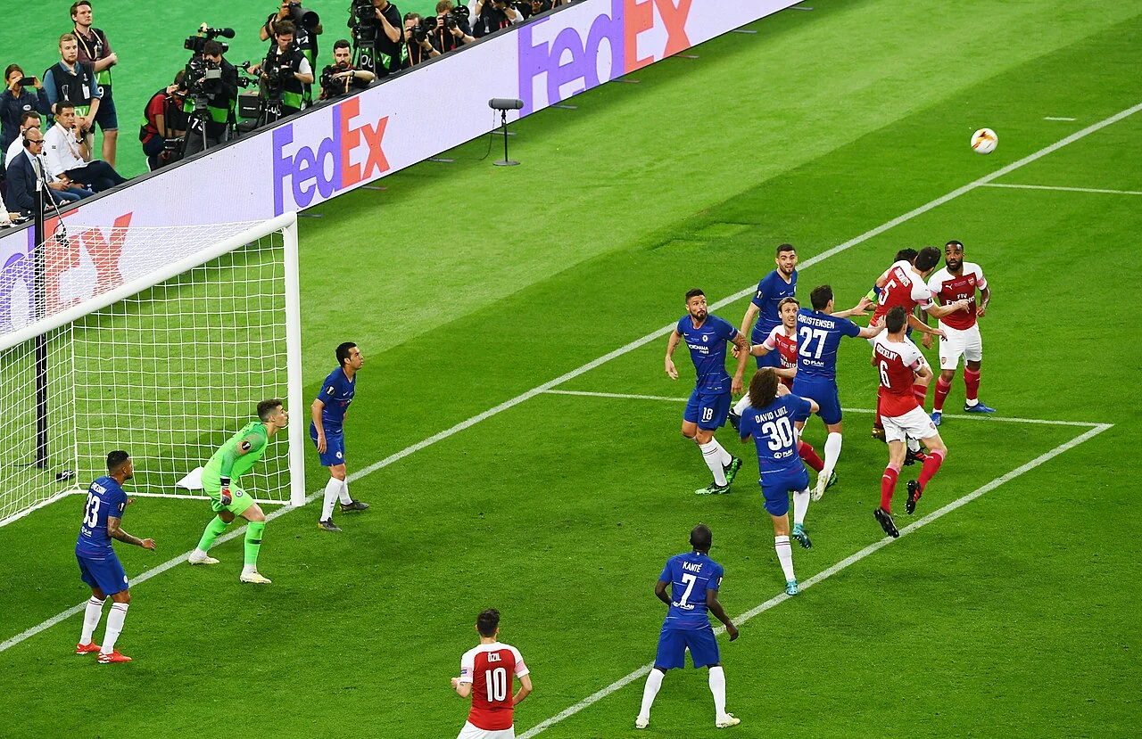 Football teams line up before a major European final in a stadium.