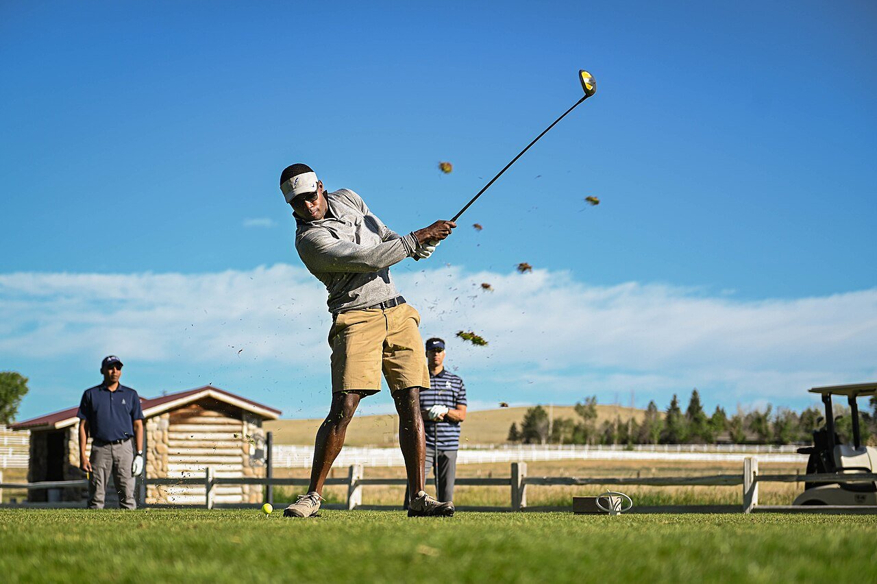 A golfer plays a shot during an outdoor tournament.