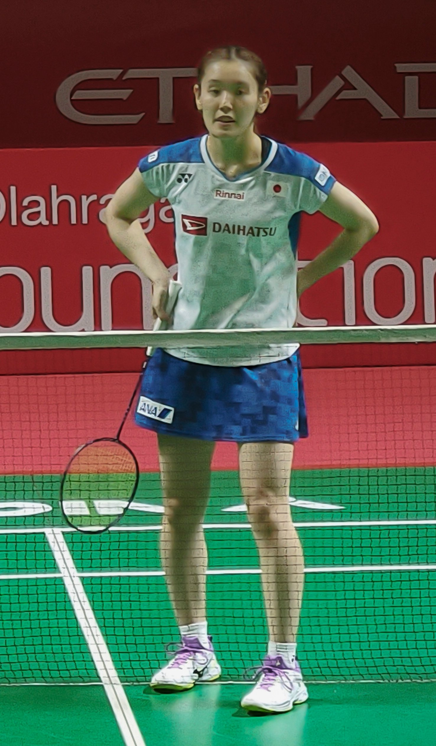 Japanese badminton player Rin Iwanaga competes at an international tournament.