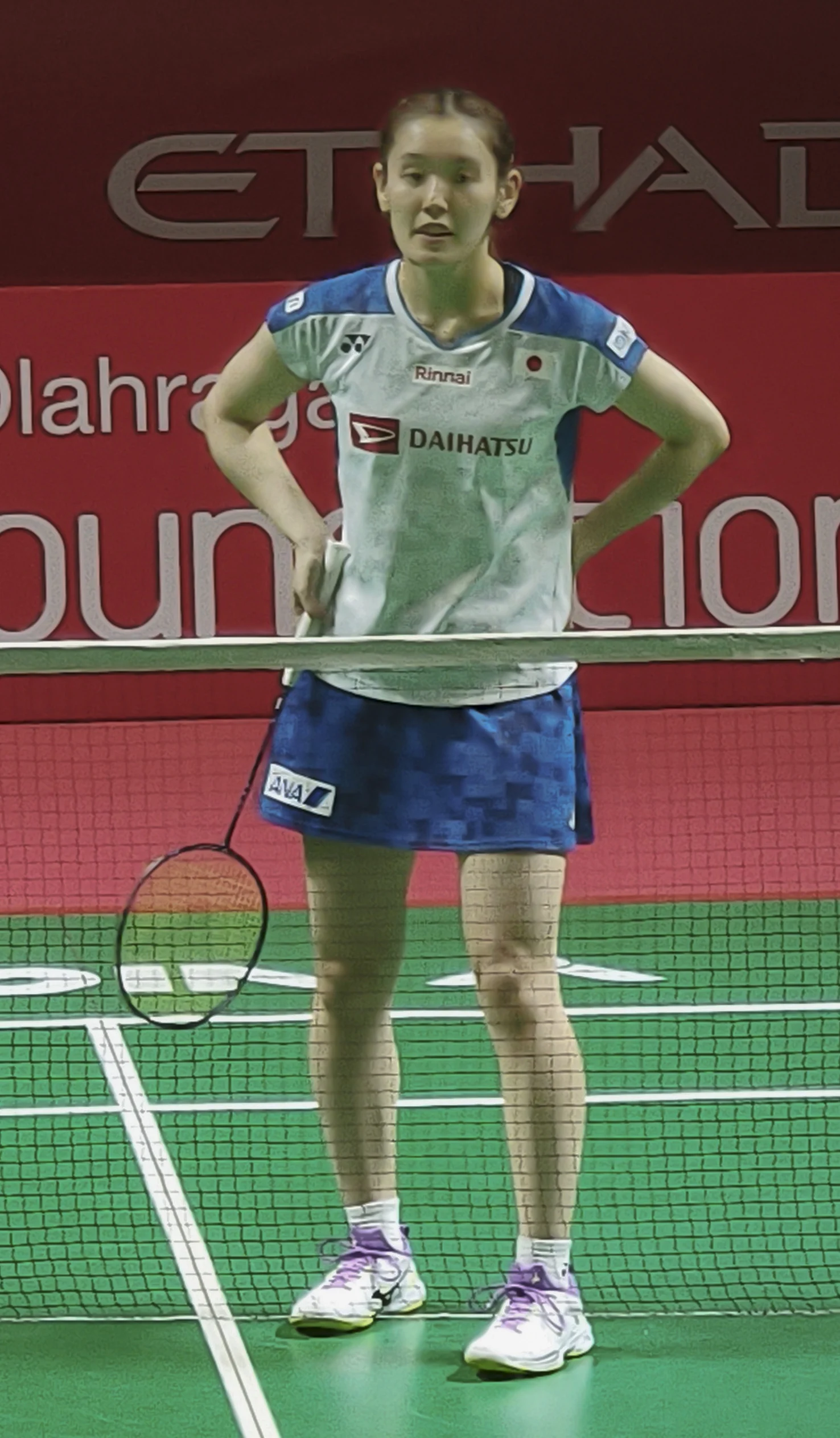 Japanese badminton player Rin Iwanaga competes at an international tournament.
