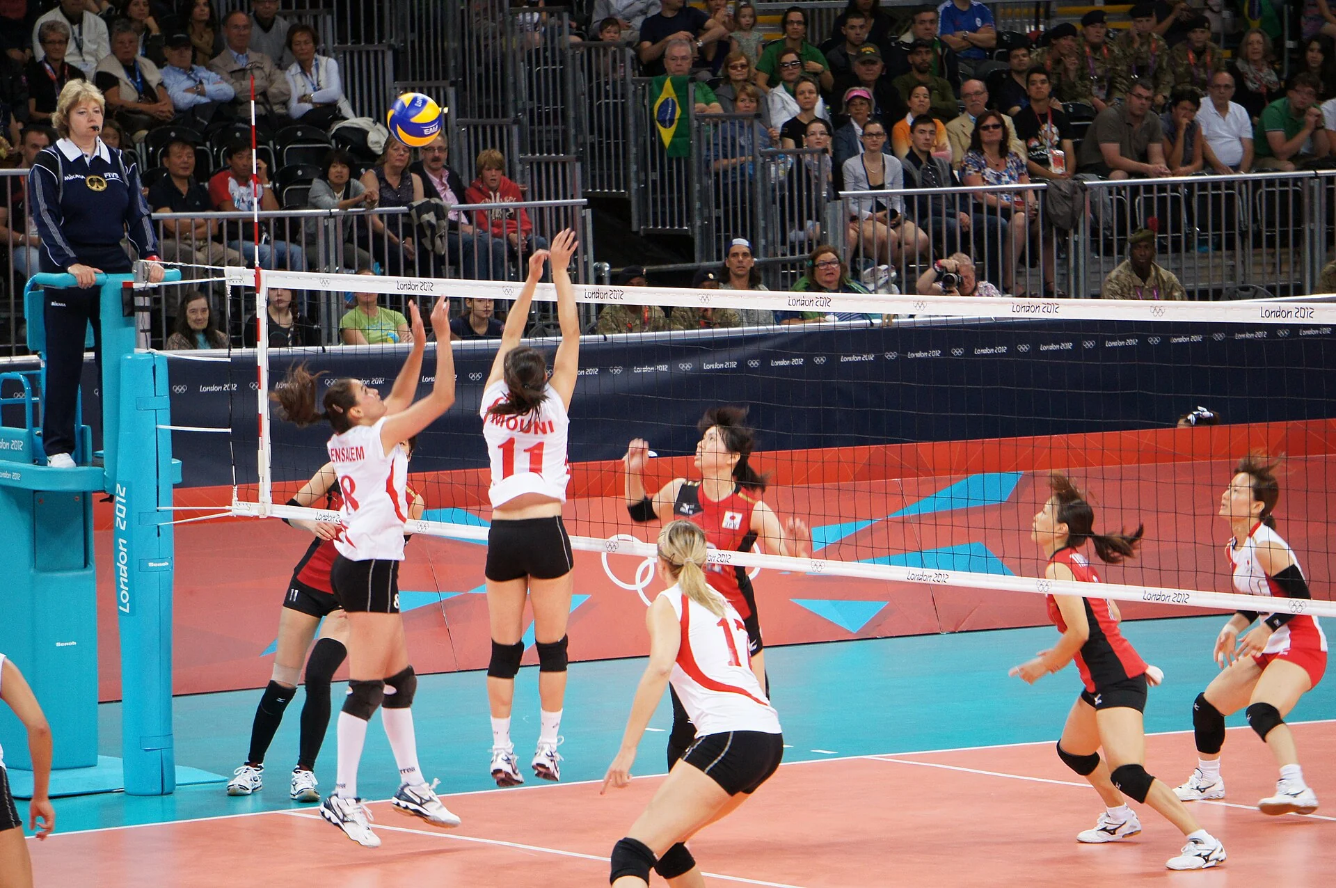 Japan's national volleyball team gathers on court during an international match.
