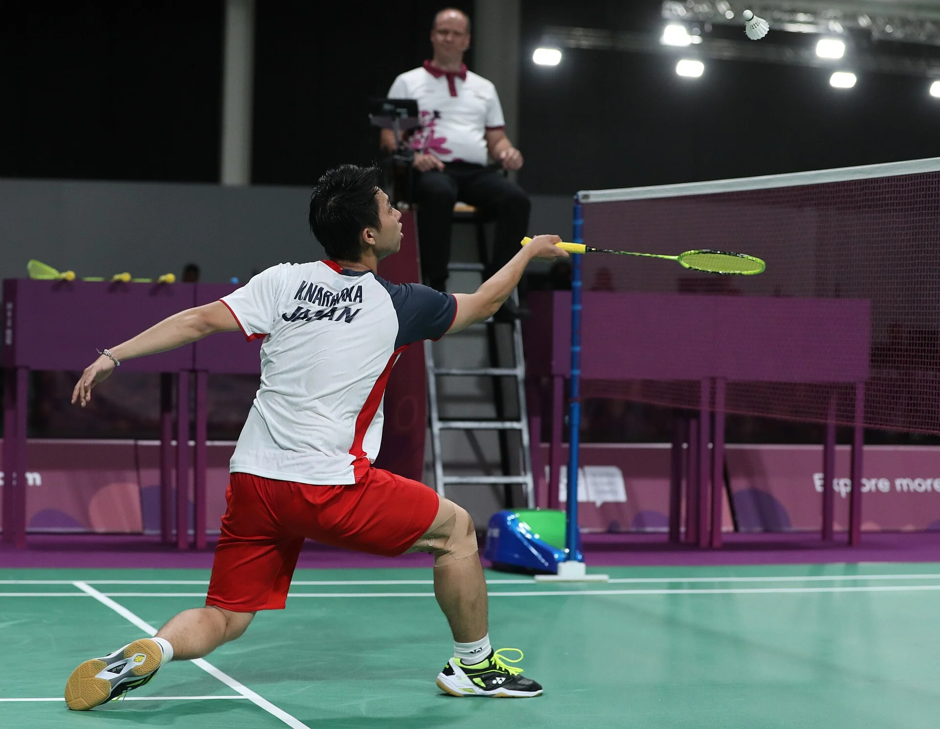 A badminton player reaches for a return during an international singles match.