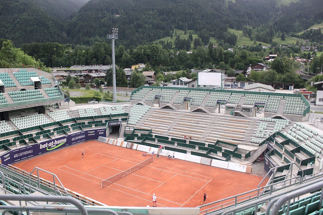 The clay courts and mountain setting of the Kitzbuhel tennis stadium.