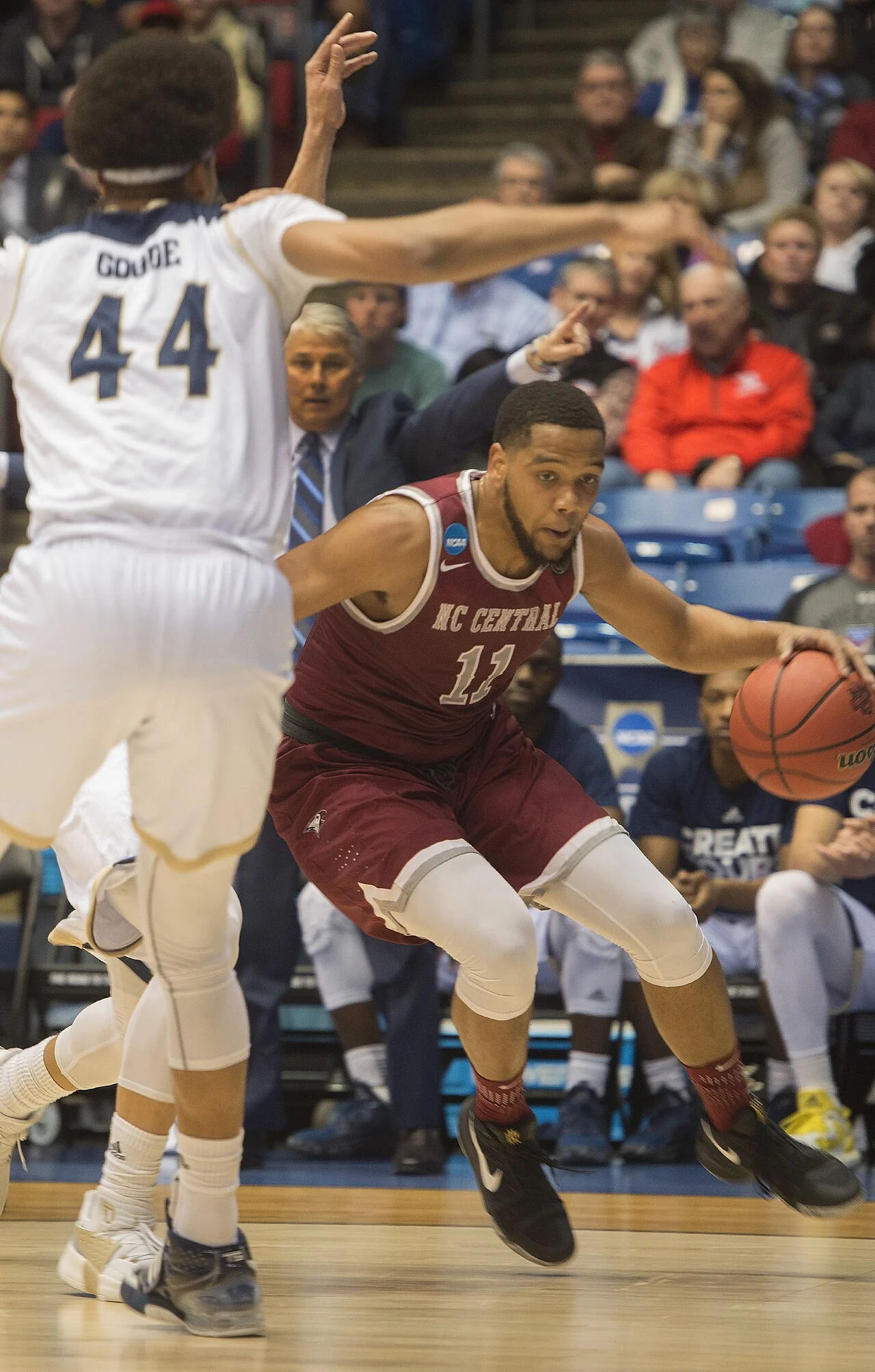 College basketball teams compete during an NCAA First Four game.