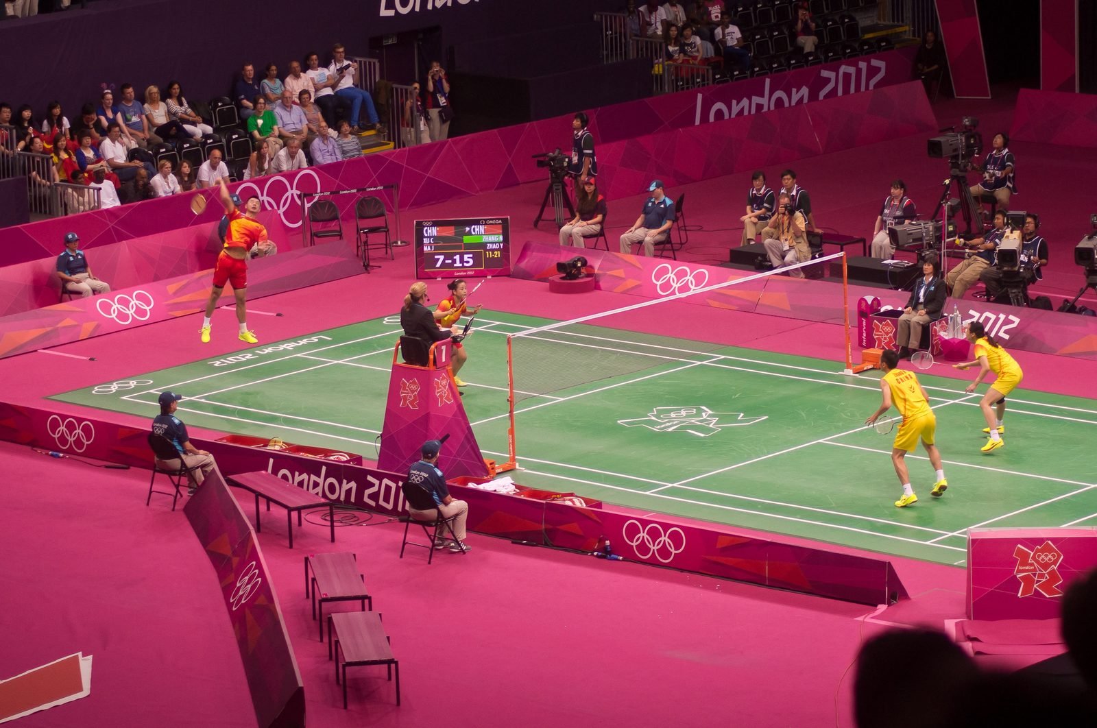 Mixed doubles players compete in an Olympic badminton final.