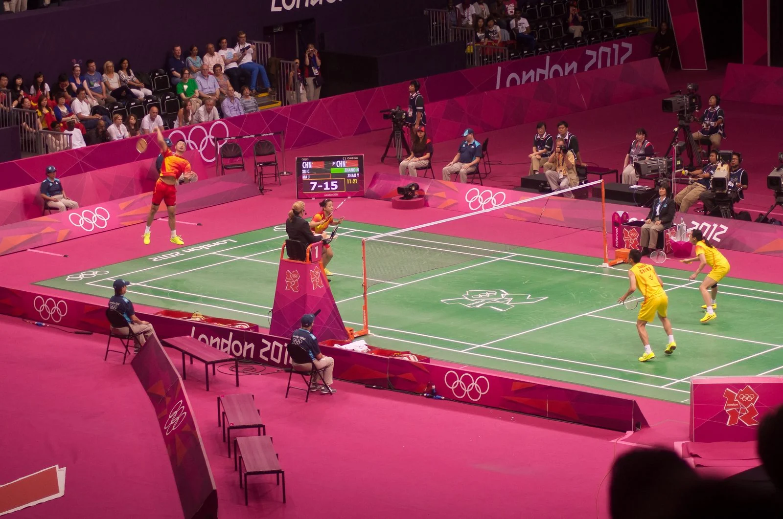 Mixed doubles players compete in an Olympic badminton final.
