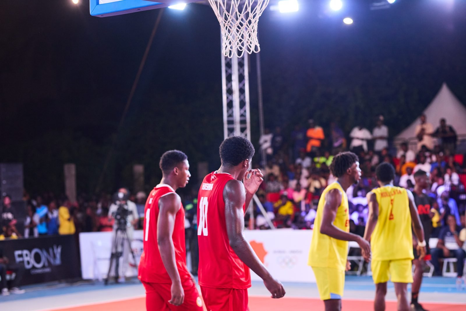 Two teams contest a fast outdoor 3x3 basketball game.