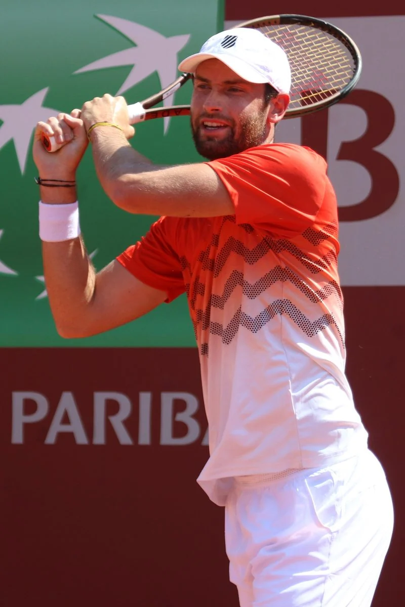 Quentin Halys prepares to serve during a professional tennis match.