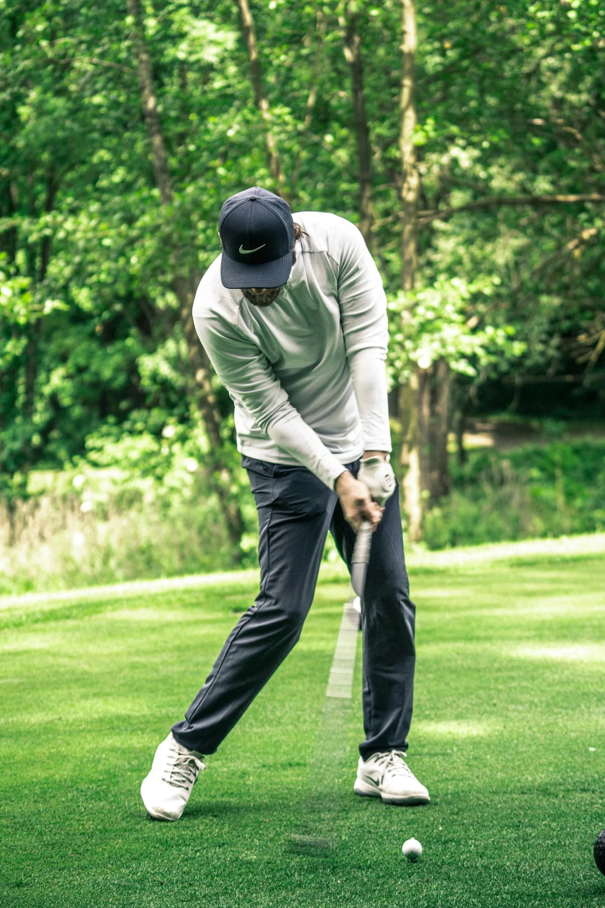 A golfer taking a shot on a golf course.
