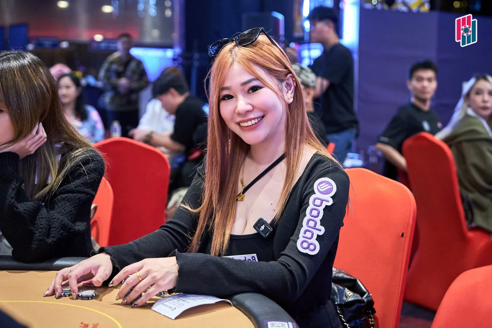 Aw Ee Ling at a Poker Dream 26 table wearing Boda8 branding.