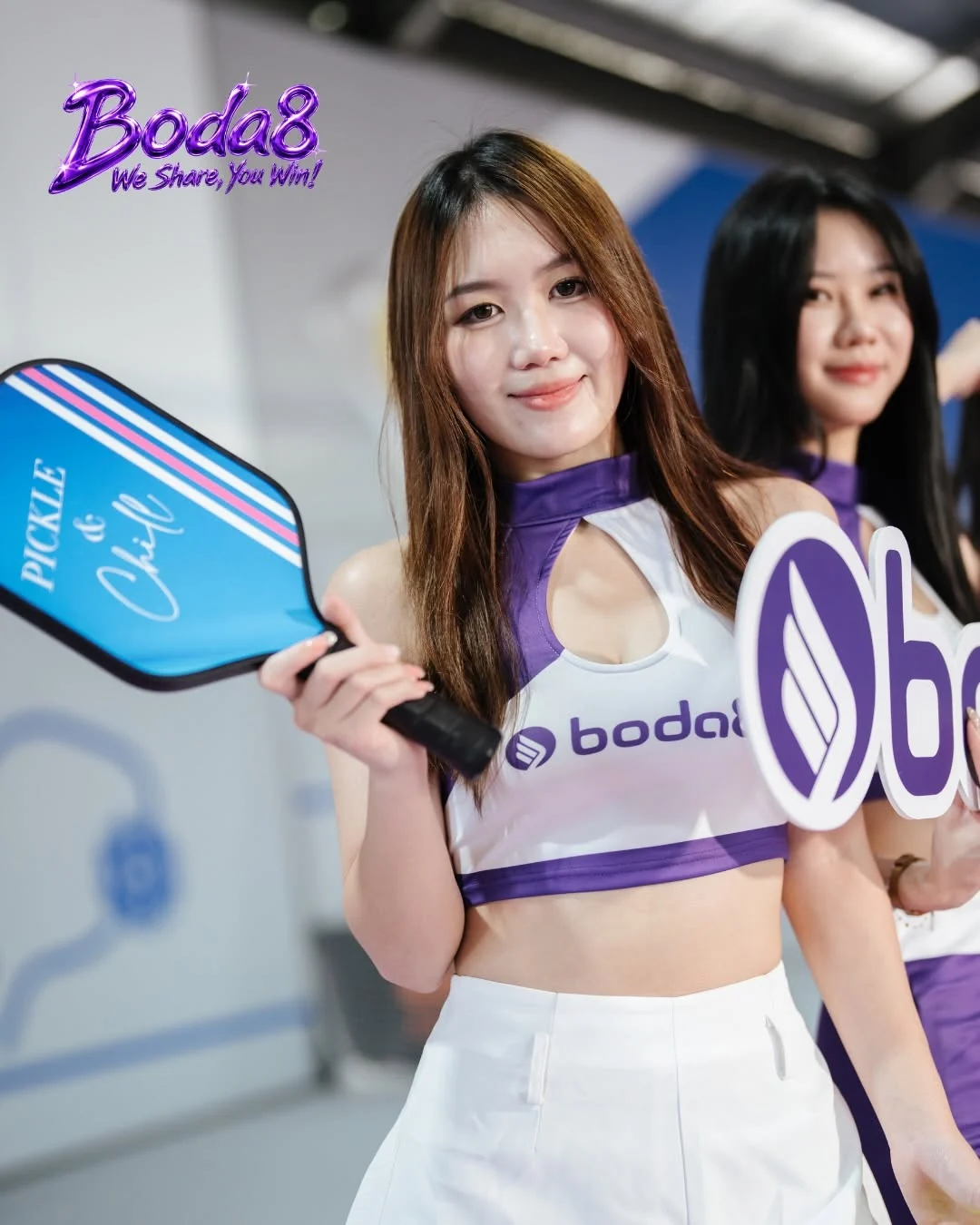 Boda8 Sport representatives holding pickleball and Boda8 event branding.