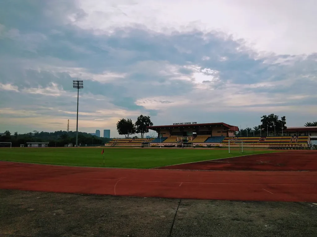 Sports Centre at Universiti Putra Malaysia with a football field, running track and grandstand.